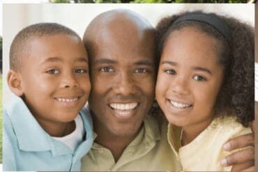 Smiling father with two children